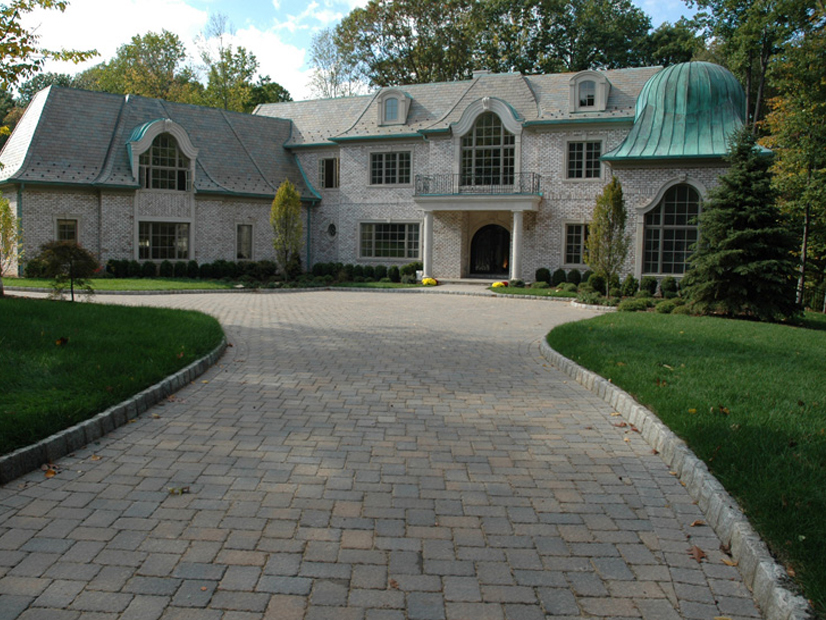A stone pathway is front of a house