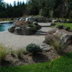 A patio with stone landscaping