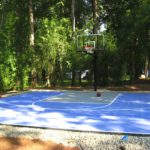 A basketball court is shown in the backyard