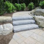 A stone patio with white steps